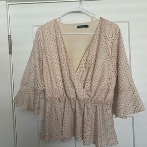 Cream colored with brown polka dots blouse. Size 10. Brand is Nasty Gal.